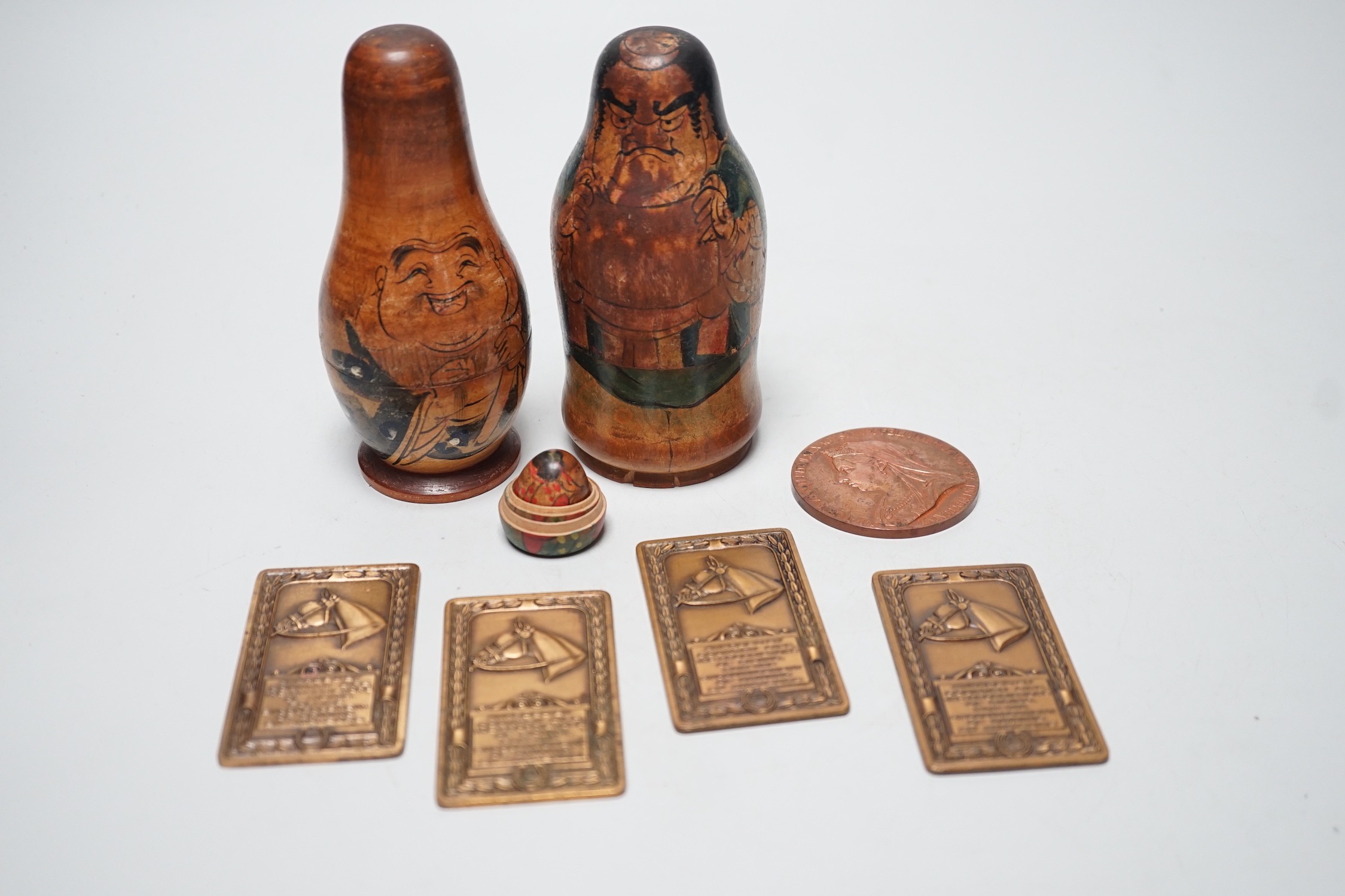 Two Japanese stacking dolls and various medallions